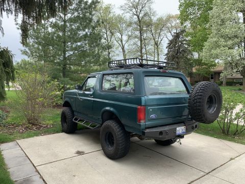 1996 Ford Bronco - This 1996 Ford Bronco is equipped with a roof rack and a rear-mounted spare tire.