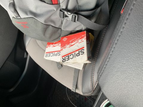 1996 Ford Bronco - Boxes of Spicer drivetrain parts are visible on a car seat.