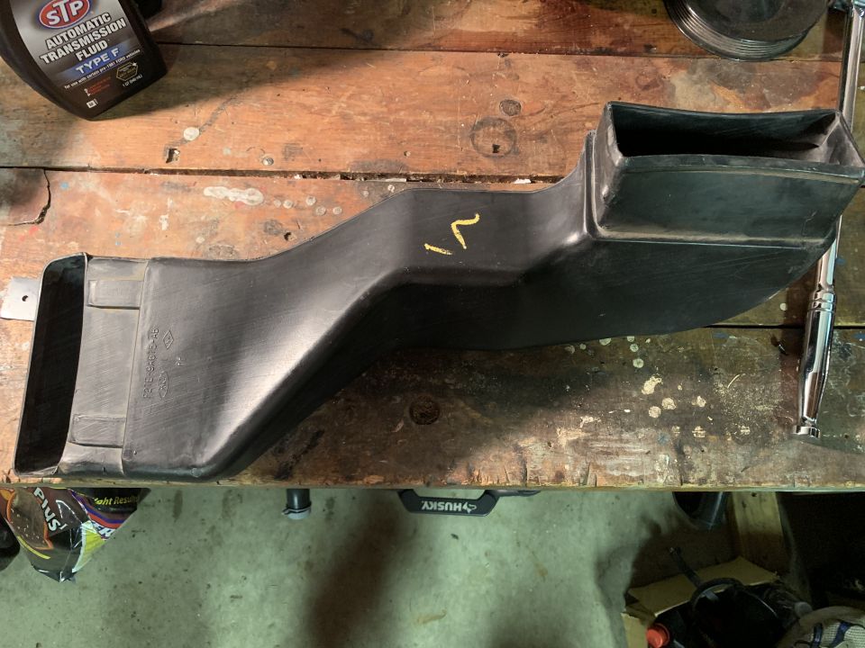Black plastic air intake duct with yellow markings
