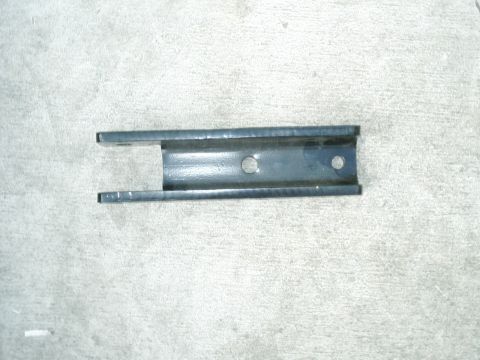 1984 Ford Bronco - A metal bracket is shown against a concrete background.