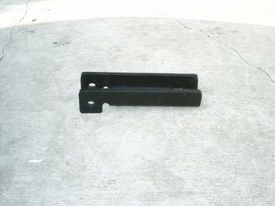 Black metal bracket with two holes and a cutout