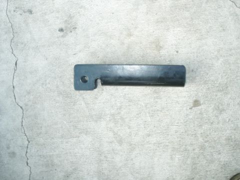 1984 Ford Bronco - A single metal bracket is shown against a concrete background.