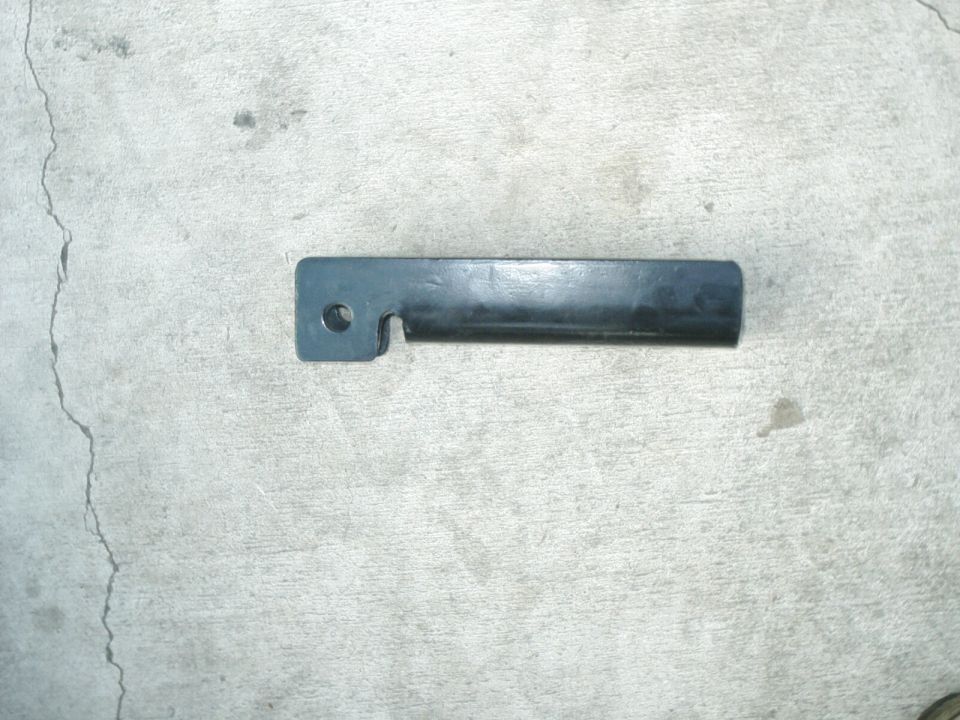 Dark metal bracket with a hole and a notch