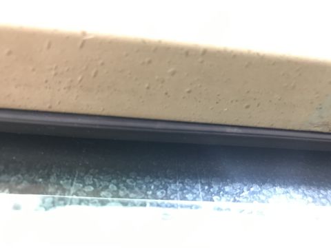 1994 Ford Bronco - A close-up shot shows a section of a vehicle's exterior, focusing on a body panel and a window.