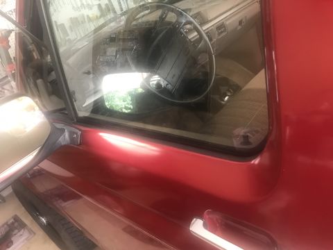 1994 Ford Bronco - Interior view of a red SUV, showing the dashboard, steering wheel, and seats.