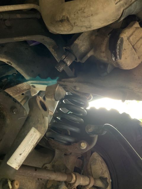 1996 Ford Bronco - Close-up of the vehicle's front suspension and steering system components.
