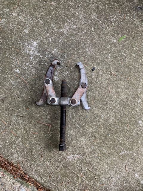 1996 Ford Bronco - A gear puller tool is shown on a concrete surface, with a website address visible in the lower right corner.