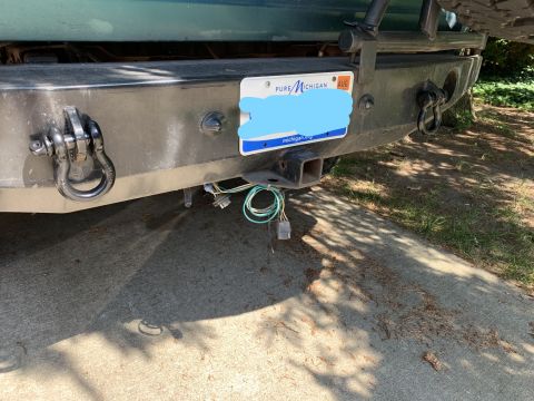 1996 Ford Bronco - The rear of a 1996 Ford Bronco shows a tow hitch and wiring harness attached to the bumper.