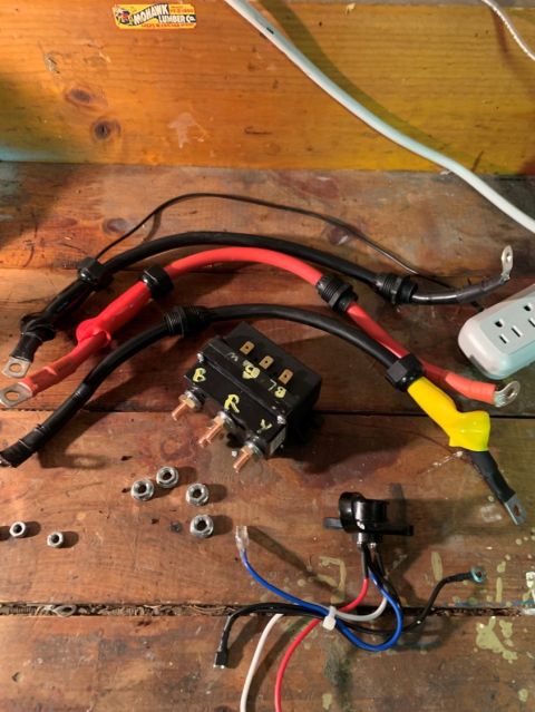 1996 Ford Bronco - Various automotive electrical parts laid out on a workbench, including a relay and wiring.
