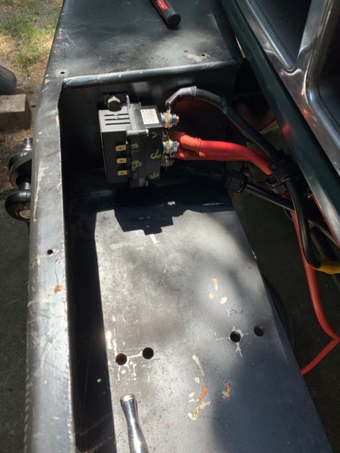 1996 Ford Bronco - An electrical relay and wiring are visible within a vehicle's metal compartment.