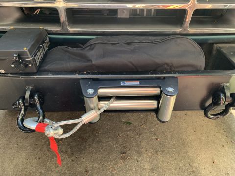 1996 Ford Bronco - Front view of a 1996 Ford Bronco a winch, tow hooks, and a black cover over the grille area.
