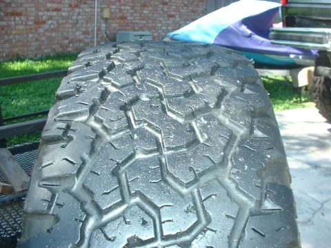 1984 Ford Bronco - Close-up of a tire's tread pattern, with the Supermotors.net logo visible in the lower right corner.