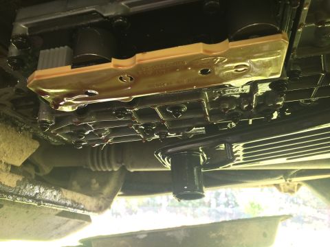 1993 Ford Bronco - Underside view of a vehicle's transmission pan and filter, with visible fluid leaks.