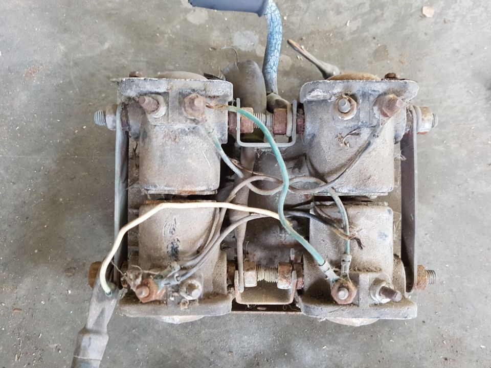 Dusty electrical solenoid assembly with wires and bolts
