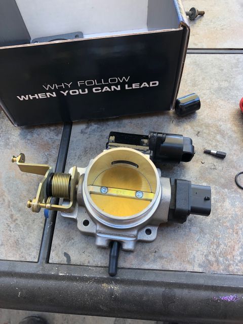 1992 Jeep Wrangler - Throttle body assembly and associated parts laid out on a surface, with a box in the background.
