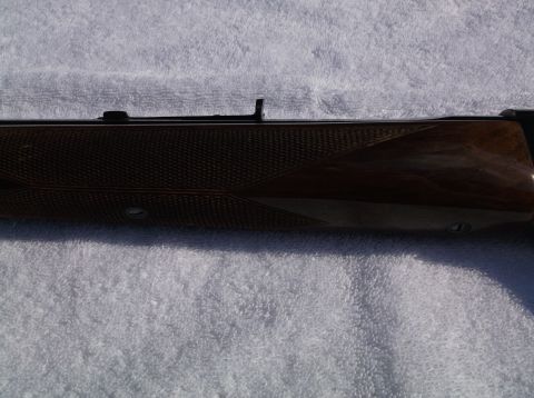 1995 Mercury Grand Marquis - Wooden rifle stock with checkering and metal sights visible.