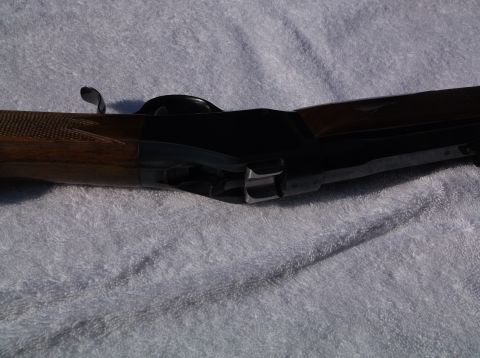 1995 Mercury Grand Marquis - A close-up view of a Browning shotgun receiver and part of its wooden stock.