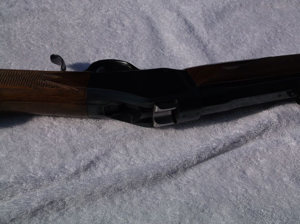 Browning shotgun receiver with wood stock and metal action, viewed from the side