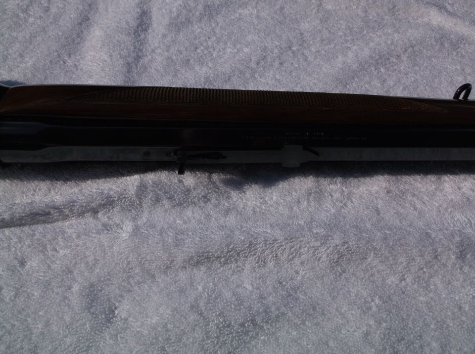 Close-up of a Browning shotgun receiver with wood stock
