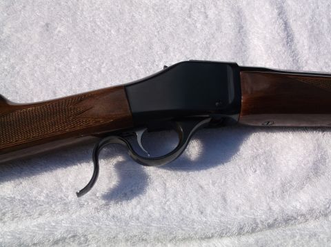 1995 Mercury Grand Marquis - Close-up view of a Browning lever-action rifle, showing the wood stock and black receiver.