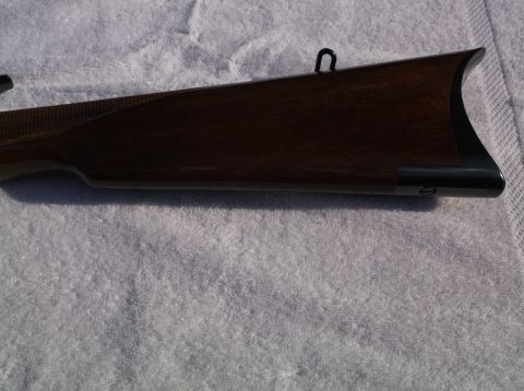1995 Mercury Grand Marquis - Close-up of a rifle's wooden stock and metal components.