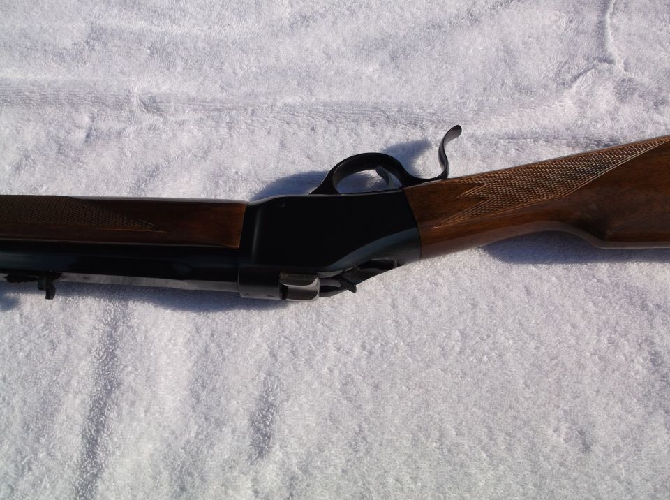 Close-up of lever-action rifle mechanism and wooden stock