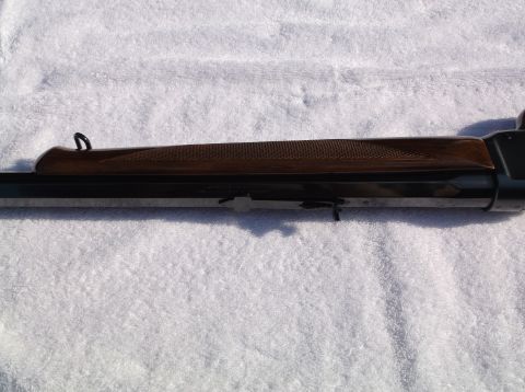 1995 Mercury Grand Marquis - This is a close-up view of a rifle's receiver and wooden stock.