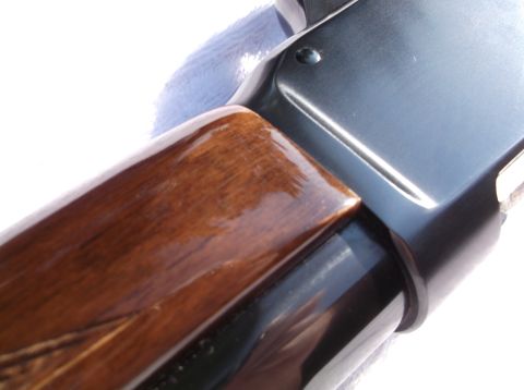 1995 Mercury Grand Marquis - A close-up view of a firearm's wooden stock and metallic receiver.