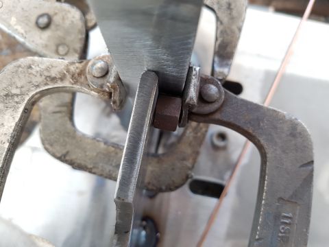 1978 Ford Bronco - Close-up of metal clamps and fasteners, with a Supermotors logo in the corner.