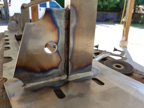 1978 Ford Bronco - Welded metal bracket with heat discoloration and a circular cutout, possibly a custom part.