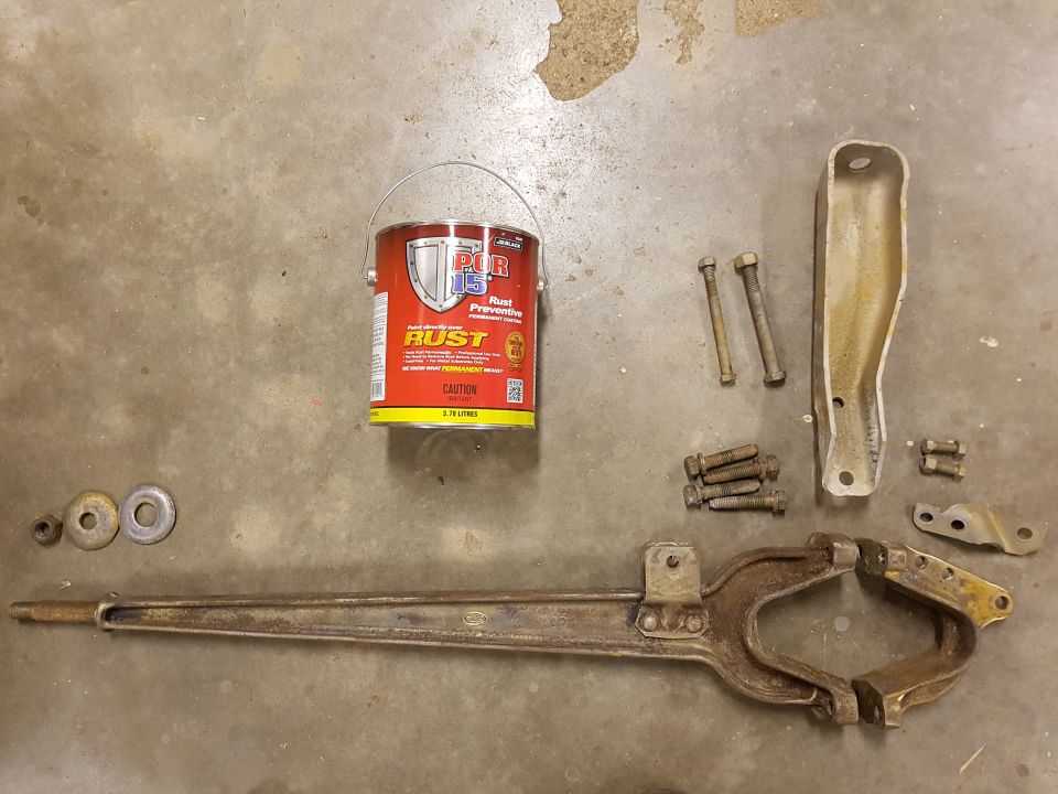 Assorted rusty automotive parts and a can of POR-15 Rust Preventive