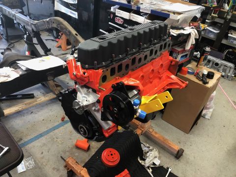1992 Jeep Wrangler - Engine assembly on a stand in a workshop, with a partial vehicle frame visible.