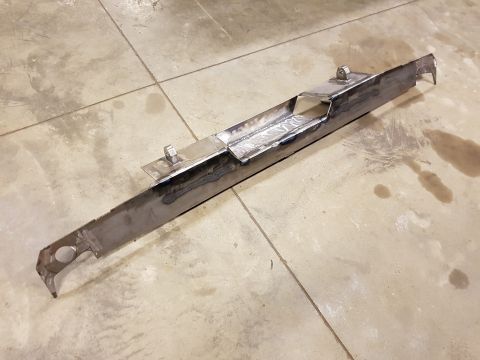 1978 Ford Bronco - A custom fabricated steel component, likely for a vehicle, rests on a concrete floor.