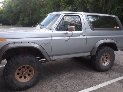 1985 Ford Bronco - This Ford Bronco is shown from the side, aftermarket wheels and tires.