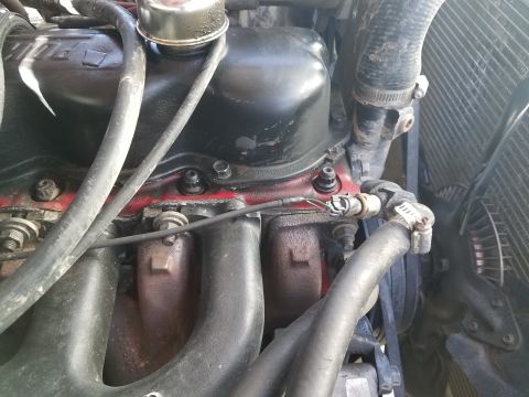 1985 Ford Bronco - Close-up view of an engine bay, showing various components and hoses.