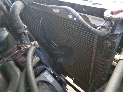 1985 Ford Bronco - The radiator and fan assembly are visible in this engine bay shot.