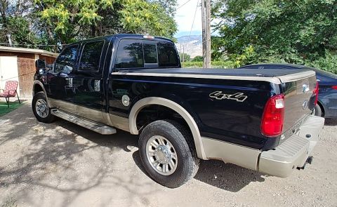2010 Ford F-250 - This Ford F-250 Super Duty pickup truck has a two-tone paint scheme and a bed cover.