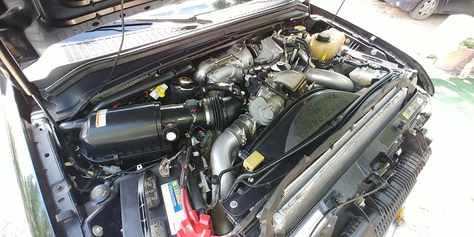 Engine bay with turbo diesel V8 labeling on fan shroud