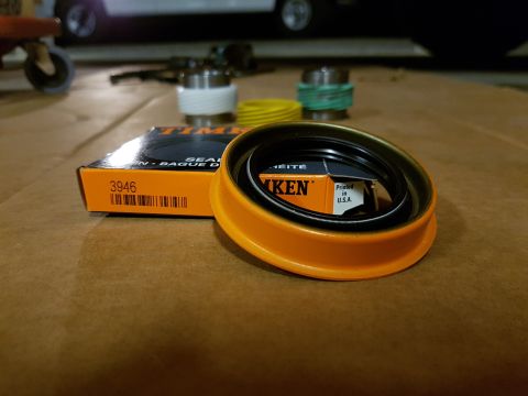 1978 Ford Bronco - A close-up of a Timken wheel bearing seal, part number 3946, with its packaging and other automotive parts in the background.