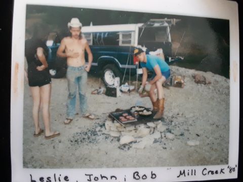 1994 Ford Bronco - People gathered around a campfire grill with a Ford truck in the background.