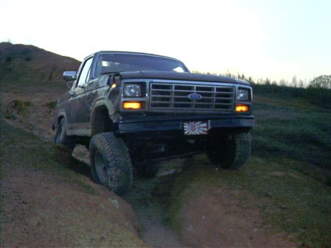 1985 Ford Bronco - This 1985 Ford Bronco navigates a steep dirt incline, its off-road capabilities.
