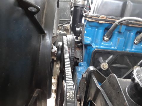 1985 Ford Bronco - Engine belts and pulleys are shown in detail, with a blue engine block in the background.
