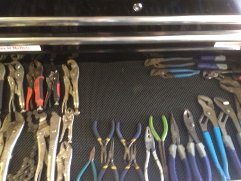 1992 Jeep Wrangler - A collection of pliers and wrenches organized in a tool drawer.