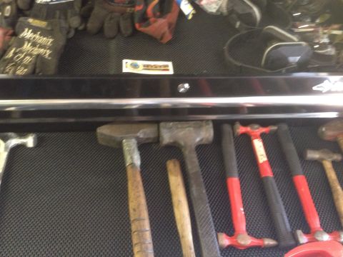 1992 Jeep Wrangler - A collection of hammers and work gloves are organized in a tool drawer, with a SuperMotors logo visible.