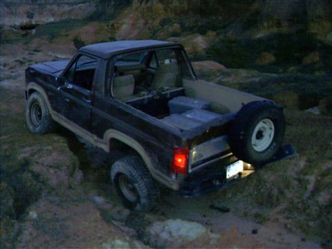 1985 Ford Bronco - This 1985 Ford Bronco is navigating a rocky, off-road trail at dusk.