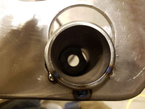 1978 Ford Bronco - This image shows a close-up view of a metal exhaust pipe, visible welds and a brushed metal finish.