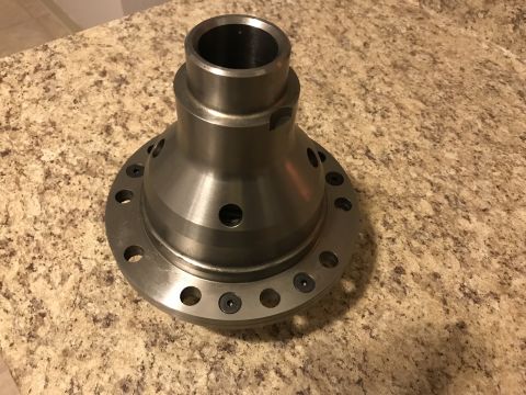 1987 Ford Bronco II - A close-up view of a differential carrier part sitting on a speckled countertop.