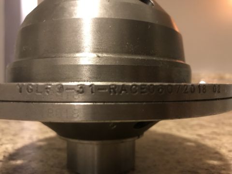 1987 Ford Bronco II - Close-up of a differential part showing stamped identification numbers and a date of 06/07/2018.