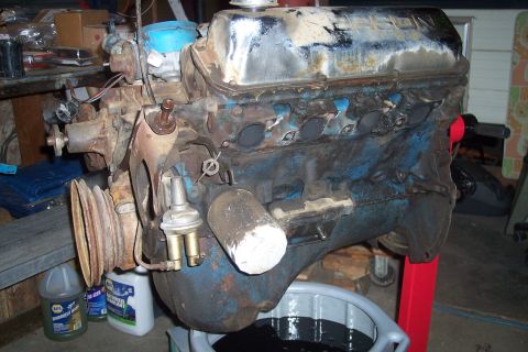 1978 Ford Bronco - Engine assembly with blue block and chrome valve covers, resting on a red engine stand.