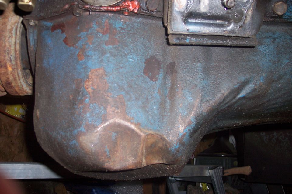 close-up of rusty blue engine oil pan